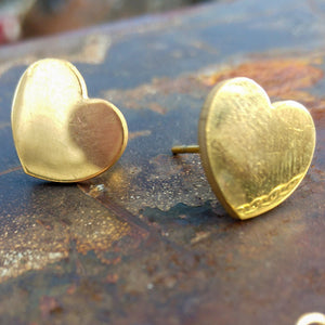 Small gold-colored heart stud earrings