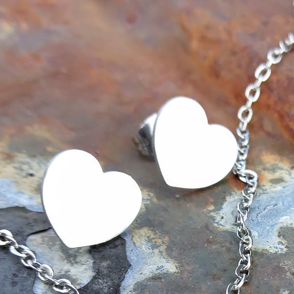 Small silver-colored heart stud earrings